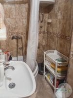 a bathroom with a shower curtain and sink